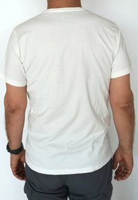White cotton t-shirt with a crew neck and short sleeves, featuring a smooth texture and simple design. Viewed from the back.