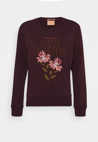 Sudadera burdeos de manga larga, con bordado floral y el texto "WILD FLOWER" en un color contrastante. Cuello redondo, puños acanalados.