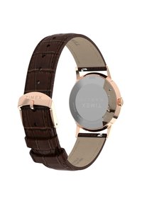 Curea din piele cu model de crocodil maro, cu carcasă din aur roz lustruit. Fața clară a ceasului cu brandul "Timex"; rezistent la apă până la 30 de metri.