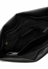 Black leather clutch with textured surface, featuring an interior zip pocket and additional compartments, all lined in black fabric.