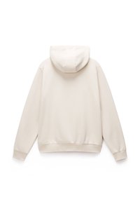 Felpa con cappuccio beige dal taglio rilassato, con polsini e orlo a costine. Tessuto morbido, con una tasca a marsupio sul davanti.