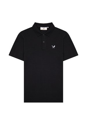 Camiseta polo negra de manga corta con tapeta de dos botones y pequeño logo blanco de cuchillo cruzado y espátula en el pecho izquierdo.