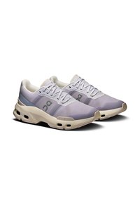 Light purple athletic shoes with a mesh upper, reinforced toe, and cushioned sole. Features decorative accents and lace eyelets.