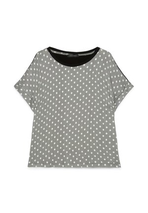 Blusa a maniche corte bianca e nera con righe verticali e piccolo motivo ovale bianco, scollatura rotonda con bordo nero solido.