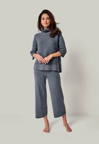 Gray knit sweater with a high collar and three-quarter sleeves, paired with matching wide-leg pants. Soft texture and casual design.