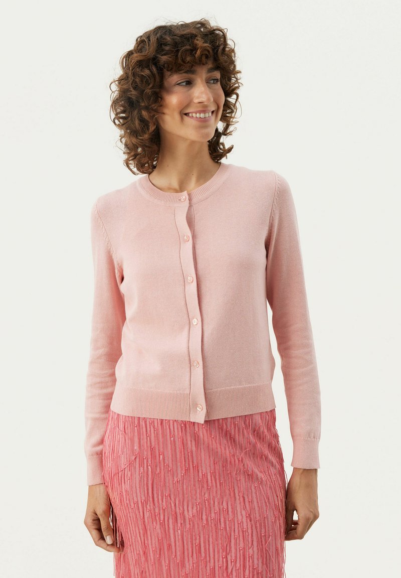 Light pink cardigan made of soft knit fabric, featuring a round neckline, long sleeves, and button front closure.