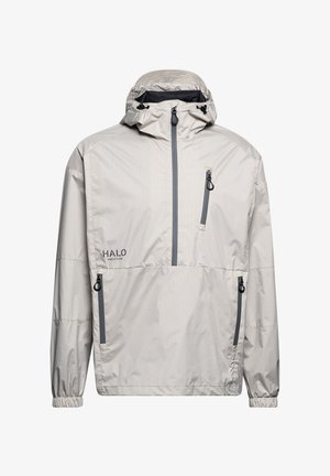 Lichtbeige waterdichte jas met hoge kraag, trekkoordcapuchon en twee ritszakken. Beschikt over elastische manchet en logo op de voorkant.