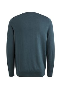 Crewneck-Pullover in Dunkeltürkis, aus weichem Stoff gefertigt. Mit langen Ärmeln, gerippten Bündchen und einer Seitentasche mit Klappdetail.