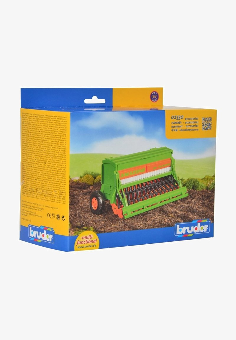 Green toy seed drill with orange accents, featuring wheels, a textured seedbed, and detailed mechanisms. Packaging includes multi-language information.