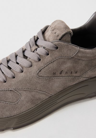 Gray suede sneaker with gray laces and rubber sole, featuring embossed text "H Ø N 8 6" on the side and tongue.