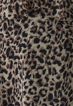 Sleeveless top in lightweight fabric featuring a beige base with a black and brown leopard print pattern and ruffled neckline detail.