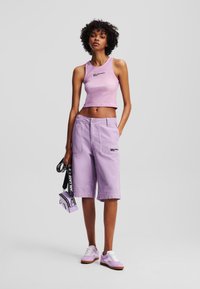 Heledasinine roosa lühike tank top logoga; vastava heledasinise värvi cargo lühikesed püksid kahetaskutega; valged tossud violetsete aktsentidega; väike kott.