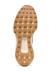 Schoenen zool met een gestructureerd beige rubberen ontwerp, voorzien van meerdere hexagonale noppen voor grip, omrand door een witte schokabsorberende rand.