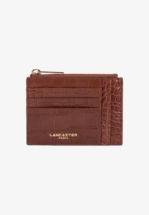 Brown crocodile-embossed leather cardholder with gold zipper, multiple card slots, and "Lancaster Paris" logo in gold lettering.