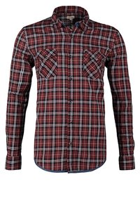 Chemise à manches longues avec boutons, motif à carreaux rouge, noir et blanc et deux poches poitrine à rabats boutonnés.