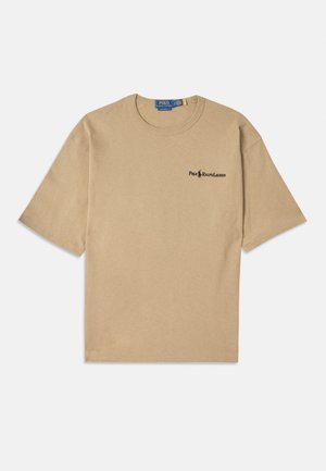 Beige cotton t-shirt with short sleeves, round neckline, and a small black logo on the left chest area. Soft texture.
