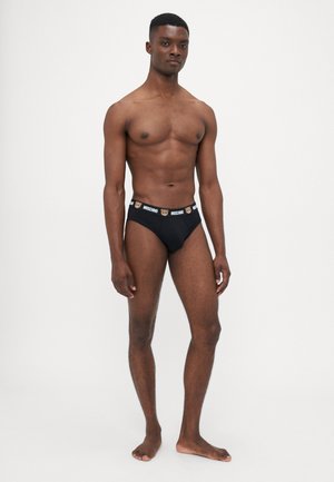Schwarze Baumwollslips mit einem Moschino-Logo-Bund, der Bärenmotive zeigt. Passgenauer Schnitt mit glatter Textur und minimaler Bedeckung.