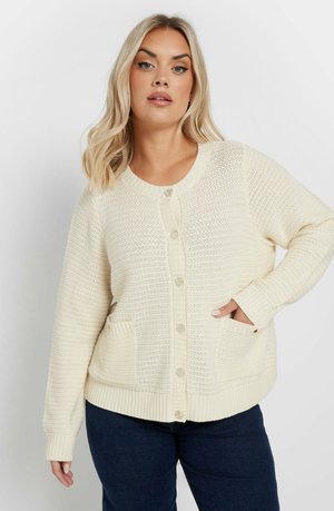 Cream knitted cardigan with a textured pattern, round neckline, button front, and two side pockets. Ribbed cuffs and hem.