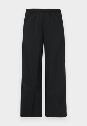 Pantalon noir à jambes larges en tissu léger avec une ceinture élastique et un détail discret de couture incurvée à l'ourlet.