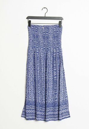 Blue and white patterned strapless dress with smocked bodice hanging on black hanger against white background.