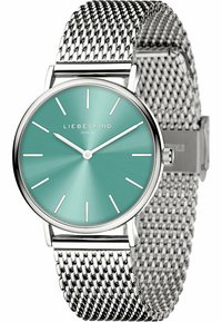 Runde Uhr mit einem mintgrünen Sonnenschliff-Zifferblatt, silbernen Stundenmarkierungen und einem Mesh-Armband aus Edelstahl. Verfügt über ein poliertes silbernes Gehäuse und eine Schließe.