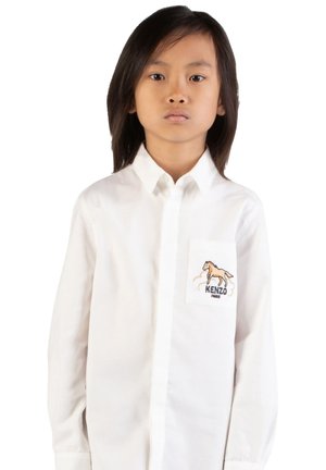 White long-sleeve shirt with a stiff collar, featuring a chest pocket that displays a brown horse and "KENZO PARIS" logo. Smooth fabric texture.