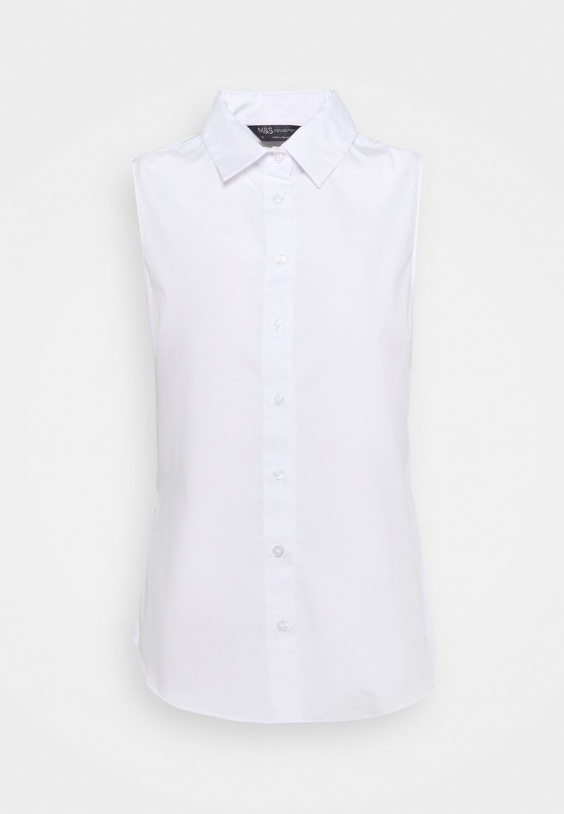 Chemise blanche sans manches avec col pointu, coupe ajustée, et boutons sur toute la longueur du devant.