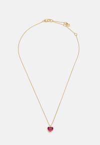 Gold chain necklace featuring a heart-shaped ruby pendant, which has a faceted surface and is set in a gold prong setting.