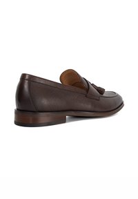 Brown leather loafers with a textured finish, decorative tassels, and a low wooden heel, showcasing a classic design.
