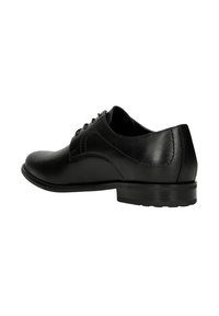 Scarpa oxford in pelle nera con punta arrotondata, superficie liscia, cuciture sottili e tacco basso impilato. Presenta un design con lacci.