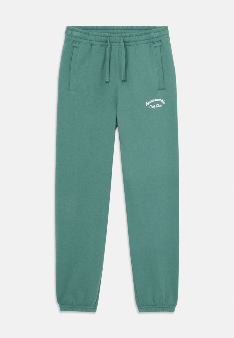 Gröna sweatpants i mjukt tyg, med elastisk midja, två sidofickor och vit broderad text på vänster lår.