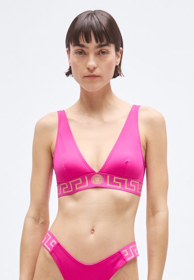Pink swimwear set featuring a triangular bra top and bikini bottom. Detailed with gold geometric patterns and a central logo on the band.