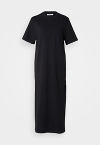 Black cotton t-shirt dress with short sleeves, a crew neck, and a loose fit, falling to mid-calf length. Smooth texture, no visible patterns.