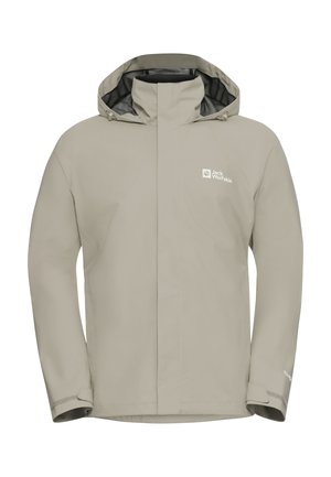 Giacca impermeabile beige con cappuccio foderato di nero, zip frontale e polsini regolabili. Presenta il logo Jack Wolfskin a sinistra.