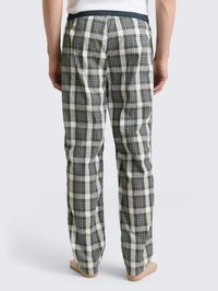 Kárované pyžamové nohavice v zelenej, bielej a čiernej farbe. Ľahká tkanina s elastickým pásom. Rovný strih s uvoľneným fitom.