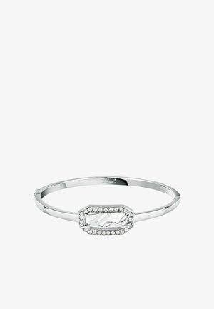 Braccialetto in argento con un centro ottagonale decorato da scritte intrecciate e circondato da strass trasparenti, finitura in metallo lucido.