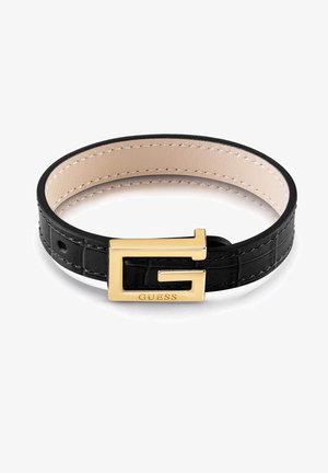 Czarna skórzana bransoletka z beżowymi wewnętrznymi przeszyciami, z pozłacaną klamrą w kształcie litery "G" z wygrawerowaną nazwą marki "GUESS".