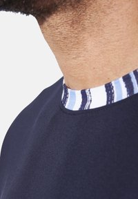 Navy t-shirt featuring a striped neckline in blue and white tones, made of smooth fabric with a close-fit design.