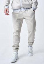 Project Tracksuit Project X Paris BANDE ÉLASTIQUE LOGOTÉE - Tracksuit bottoms - greige ...