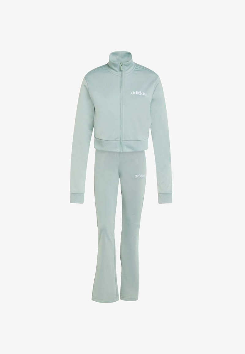Light blue tracksuit set made of soft fabric. Features a zip-up jacket with high collar and matching flared pants. Logo on chest and thigh.