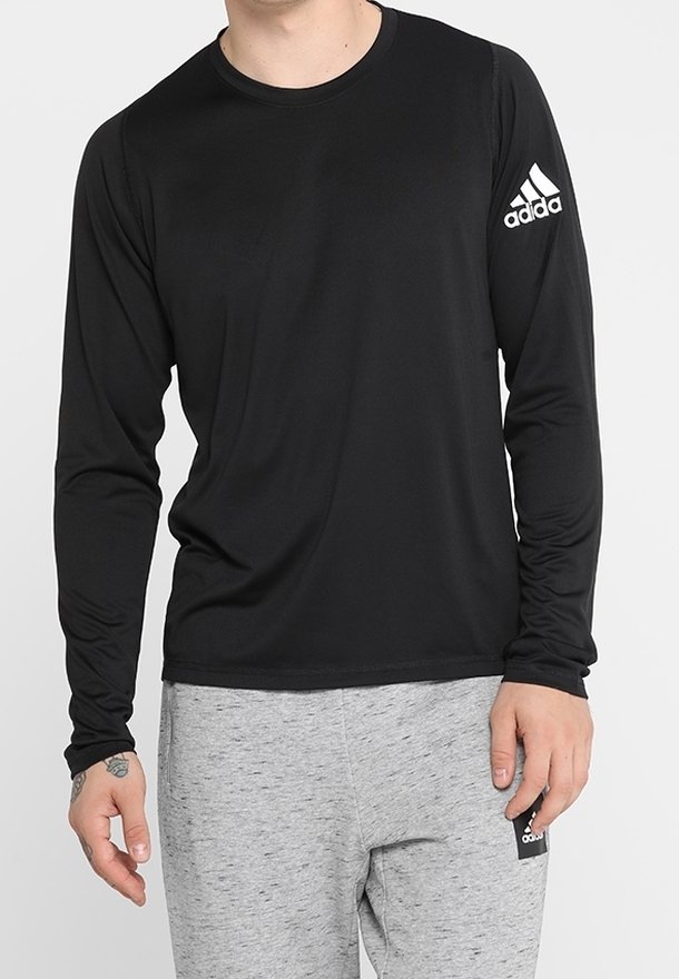 Musta pitkähihaine urheilu paita, joka on valmistettu sileästä ja kevyestä kankaasta. Vasemmassa hihassa on valkoinen Adidas-logo.