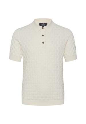 Pleteni polo majica v kremni barvi z teksturiranim kvadratnim vzorcem, tremi rjavimi gumbi in klasičnim ovratnikom. Kratki rokavi in rebrast pas.