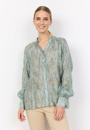 Lightweight, sheer shirt in soft green with intricate floral patterns, button front, and gathered detail at the neckline and sleeves.
