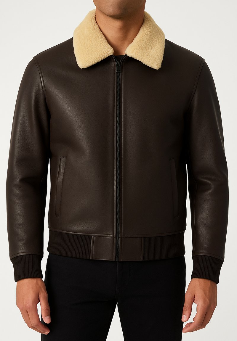 Brown leather jacket with a beige shearling collar, zipper front, and ribbed cuffs and waistband. Features side pockets for storage.