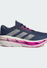 Chaussure de course bleu marine avec une tige en mesh texturé, des accents argentés et des détails roses. Elle possède une semelle rembourrée avec un talon prononcé.