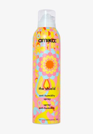 Amika The Shield anti-vocht spray in een kleurrijke roze, gele en blauwe fles met bloemenpatroon en een doorzichtige spraydop, 221 ml.