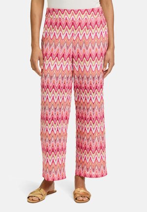 Wijd-uitlopende broek met een golvende zigzagpatroon in roze, wit en oranje. Gemaakt van lichte stof, met een elastische tailleband.