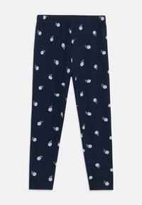 Marineblauwe legging met een elastische tailleband, met een bloemenpatroon van kleine blauwe bloemen en groene stelen gelijkmatig verspreid over de stof.