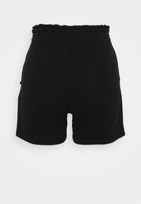 Black shorts made of a smooth fabric, featuring an elastic waistband with ruffled detail and side pockets. Form-fitting design.