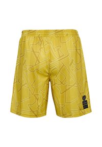 Gula simbyxor med ett abstrakt vitt geometriskt mönster, elastisk midja och en svart logotyp på nedre vänstra sidan.